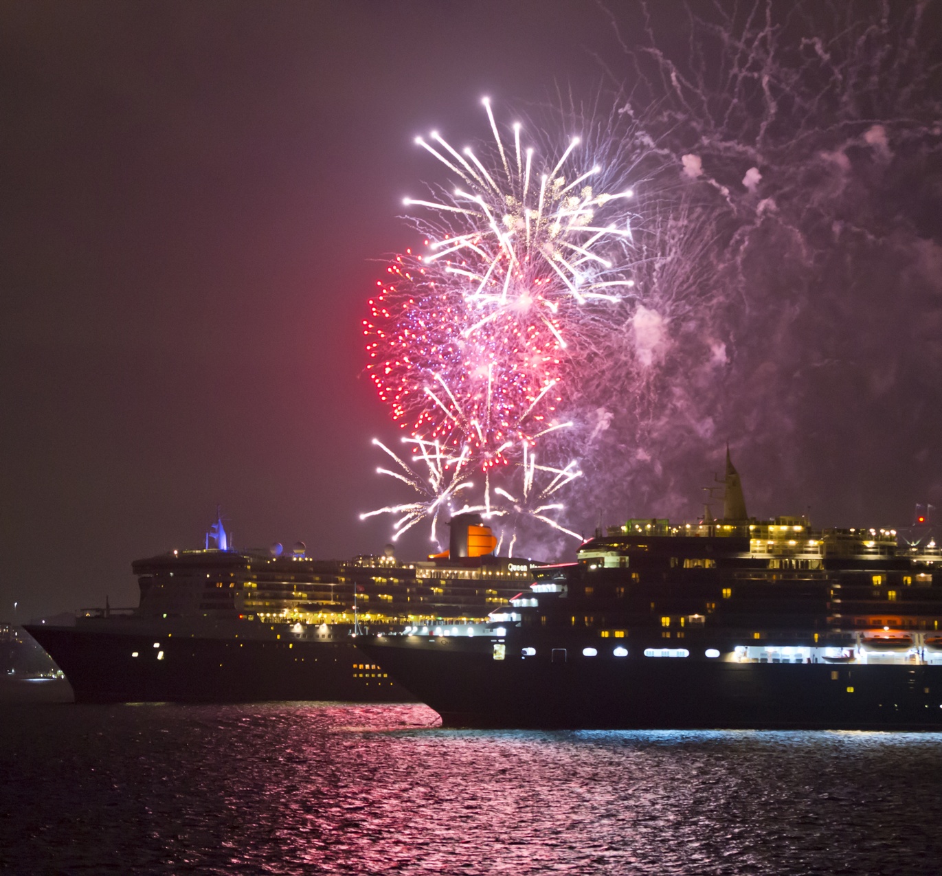 Queen Mary 2 sails by Queen Victoria as fireworks light up Sydneys sky March 12 2015 Photo by James Morgan 1